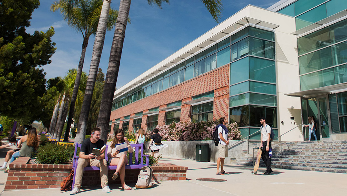 Students talking outside of Graduate School of Education