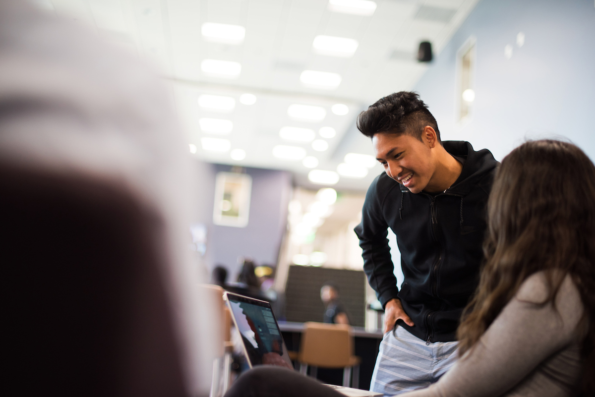 Student assistant helping student